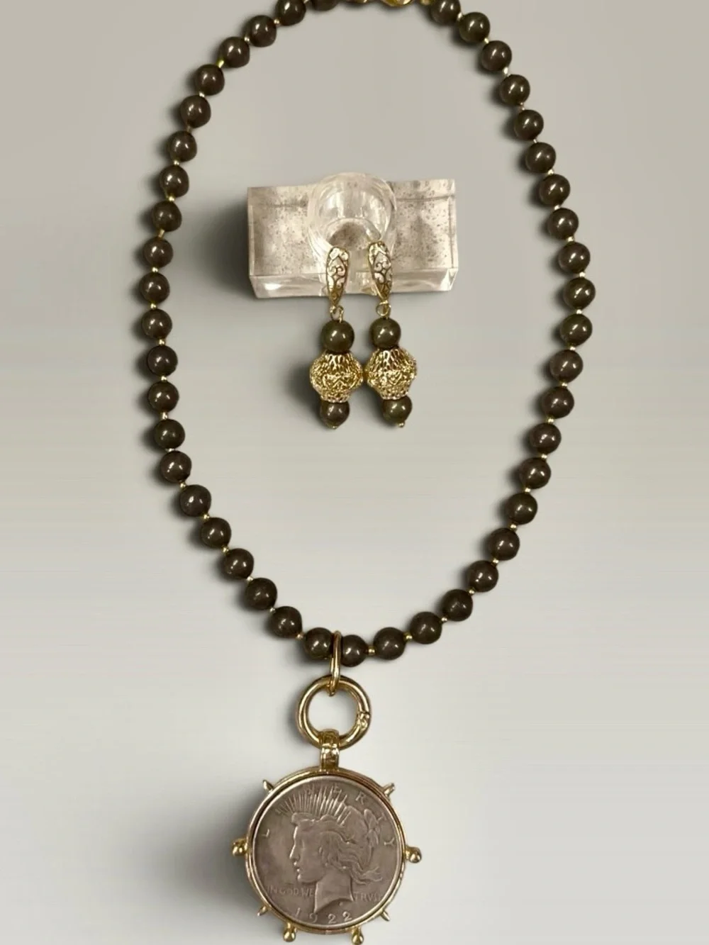 Large silver tone coin in gold tone setting on pyrite necklace with earrings